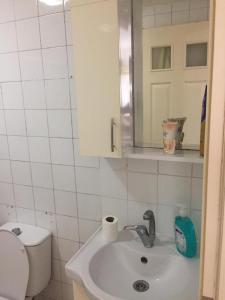 艾瓦勒克SARIMSAKLI MEYDANINDA DENİZE 0 1+1 EŞYALI DAİRE的一间带水槽、卫生间和镜子的浴室