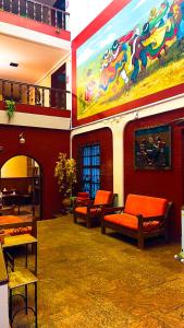 普诺Hostel Sillustani Inn Puno的一间配有沙发的房间和墙上的绘画
