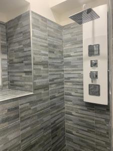 卡塔尼亚Loft Home Sweet Home的浴室铺有木质瓷砖,设有淋浴。