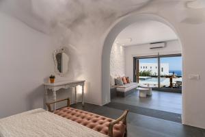 费拉Numa Santorini的一间带一张床和壁炉的卧室以及一间客厅