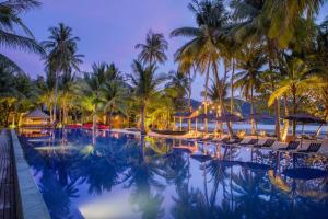 象岛Ocean Grove Pool Villa - Koh Chang的棕榈树和椅子的度假村的游泳池