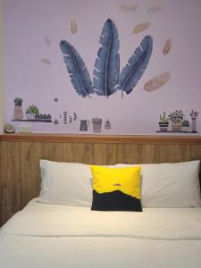 花莲市海戀初衷文旅 近東大門的卧室配有一张墙上的蓝色羽毛床。
