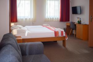 佩奇弗洛丹佩奇酒店的配有一张床和一把椅子的酒店客房