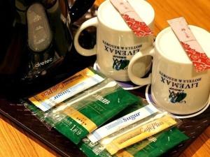 京都HOTEL LiVEMAX Kyoto Gojo的牙刷托盘和两杯咖啡