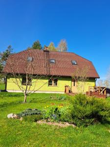 EosteKõrgemäe puhketalu的院子里有红色屋顶的黄色房子