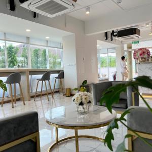 曼谷Golden Nest Hotel Suvarnabhumi的客厅配有桌椅