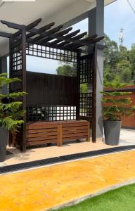 波德申Reco Villa Private Pool 4 Bedrooms@ Taman Mayung Teluk Kemang Port Dickson的天井上的木凳,种植了两盆植物