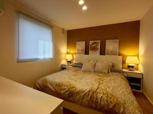 岐阜Vacanza Resort的一间卧室配有一张带两盏灯的床和一扇窗户。