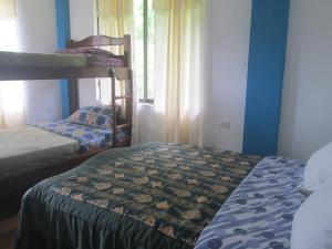巴尼奥斯CASA MARTIN en Baños de Agua Santa的客房设有两张双层床和一扇窗户。