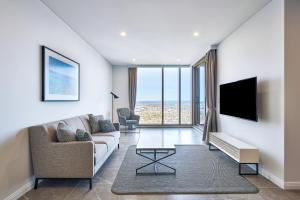 悉尼帕拉马塔乔治街美利通公寓式酒店的带沙发和电视的客厅