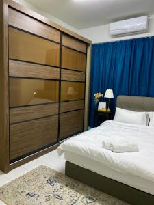 芙蓉Homestay Hana Senawang的一间卧室配有一张大床和一个大衣柜