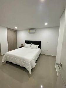 内瓦Apartamento en exclusivo lugar de Neiva的白色卧室配有一张白色的大床