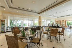 罗勇坎塔瑞海湾罗勇服务公寓式酒店的用餐室设有桌椅和窗户。