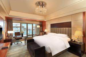 杭州杭州温德姆至尊豪廷大酒店的卧室配有一张白色大床和一张书桌