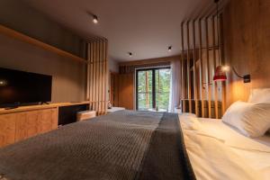 别拉什尼察Hotel Nomad的一间卧室设有一张大床和一台平面电视。