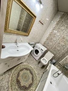 奥什Тумар的浴室配有盥洗盆、卫生间和浴缸。