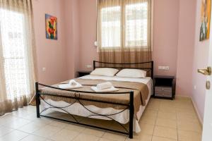 普雷韦扎Aktia Apartment, Preveza的一间卧室配有一张床,上面有两条毛巾