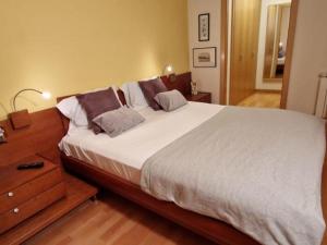 萨瓦德尔Homing Sabadell 73的一间卧室设有一张大床和一个木制床头柜。