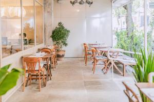 里约热内卢伊帕内玛旅馆的餐厅设有木桌和椅子,种有植物