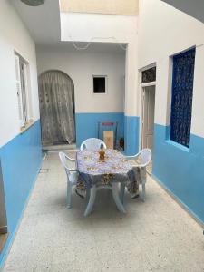 古莱比耶Le bien être的蓝色和白色的客房配有桌椅