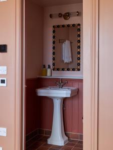 KentMargate House的浴室设有白色水槽和镜子