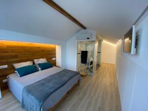 波瓦桑Casa das 7 Lombas的一间卧室配有一张大床和木制床头板