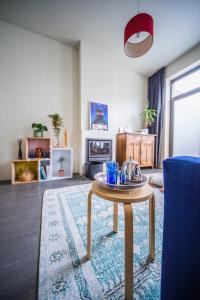 根特Casa Mina - Dok Noord Ghent的客厅配有桌子和蓝色沙发