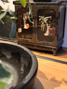 费尔德霍芬Casa Clementine - Boutique Guesthouse的电视旁边的一个花瓶,上面有画