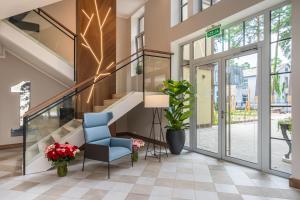 尤尔马拉STORIES Design ApartHotel的大堂设有楼梯和蓝椅