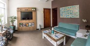 陶巴特萨玛拜亚商务酒店的带沙发和电视的客厅