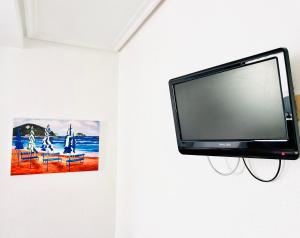 扎鲁亚斯萨劳斯酒店的挂在墙上的平面电视,挂着照片