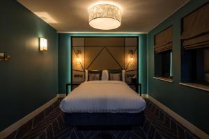 滨海绍森德赛文酒店的一间位于绿色客房内的卧室,配有一张大床