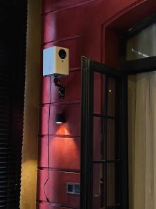 胡志明市HOTEL le JARDIN SECRET saigon的一间设有红色墙壁、扬声器和门的房间