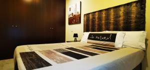 阿雷纳斯德圣佩德罗APARTAMENTO ALES II的一间卧室配有一张带大床头板的床