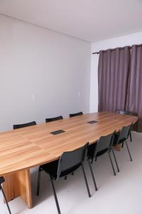 QuirinópolisHotel Borges的一间会议室,配有木桌和椅子