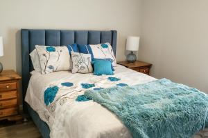 桑福德Country Quiet的一张带蓝色床头板的床和一张毯子