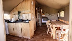 里斯本利斯博阿简易别墅酒店的一间设有厨房和一张桌子的帐篷间