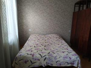 甘贾Friends Guest House的一间卧室配有一张带花卉床罩的床