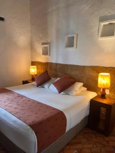 巴里查拉希卡苏阿会议中心酒店的一间卧室配有一张大床和两盏灯