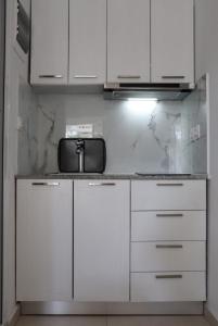 斯基亚索斯镇Fiosal Apartments 2的厨房配有白色橱柜和台面