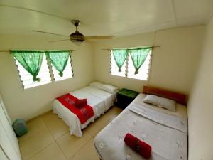 DouanePhilomena's Lodge的一间小卧室,配有两张床和两个窗户