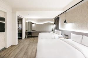 台北多郎明哥商务旅馆的酒店客房配有两张床和一张书桌