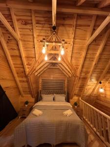 特拉布宗Zambula bungalov的卧室设有一张木制天花板上的大床