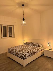 贝拉诺Emma House的一间卧室设有一张床、两盏灯和一个天花板。