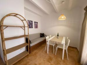 普拉加德阿罗Apartaments Margarita Sabina Pinell的配有一张床和一张桌子及椅子的房间