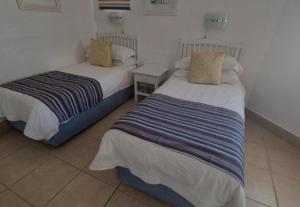 兰格班Kaliva 394, Club Mykonos的配有两张床的客房内。