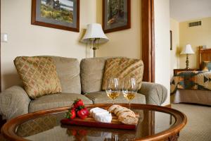 DepositChestnut Inn at Oquaga Lake的客厅配有沙发和带酒杯的桌子