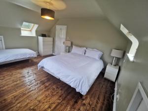Blue Stack View的卧室配有一张白色的大床,铺有木地板