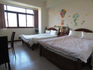 埔里雅如小築電梯民宿的酒店客房设有两张床和窗户。