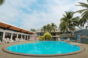 柴老海滩昭佬托桑海滩飯店的度假村的游泳池,配有椅子和棕榈树